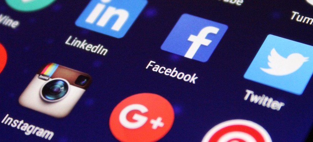 Close-up of a smartphone screen showing social media app icons, representing social media marketing trends